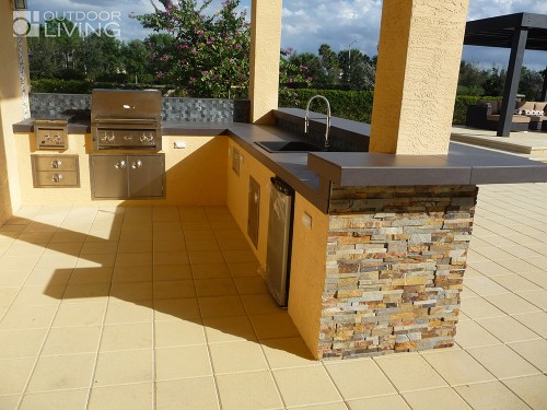 Stunning outdoor kitchen design with a concrete countertop and BBQ grill