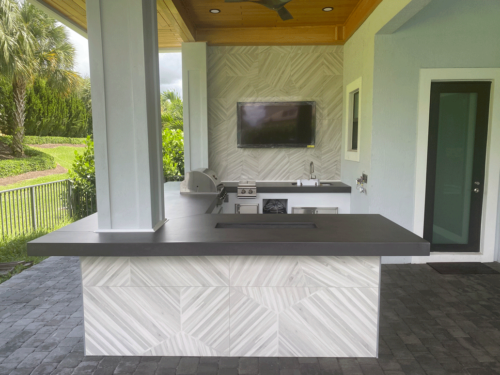 Outdoor kitchen with artistic concrete countertops and cypress ceiling