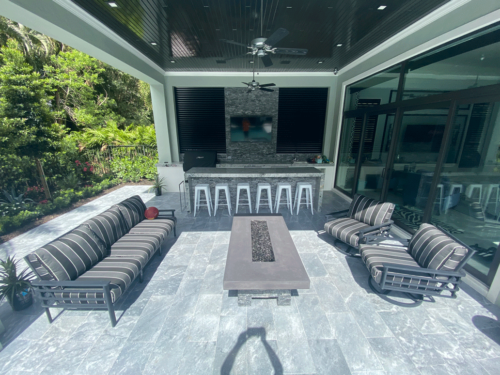 cabanas area with beautiful stain cypresswood, custom fire pit, louvered metal in openings and granite Countertops
